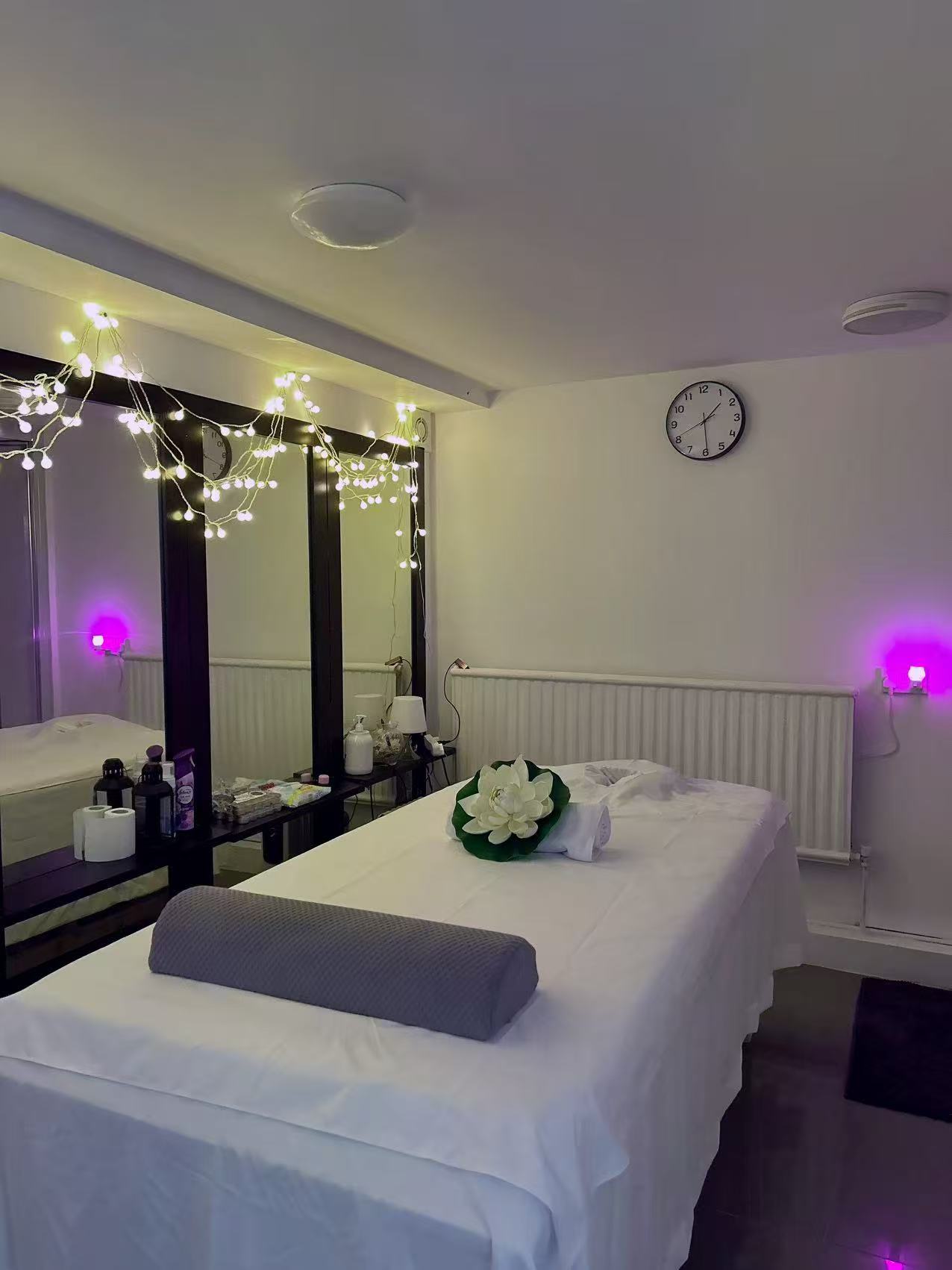 Relaxing massage treatment room with ambient lighting